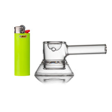 A lime green Bic lighter stands next to an MJ Arsenal Grotto Glass Pipe, a small, clear borosilicate hand pipe with a flat base and horizontal mouthpiece, both set against a white background.