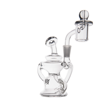 The MJ Arsenal Hydra Mini Dab Rig is a clear glass Klein recycler with a cylindrical base, curved handles, and an attached bowl and nail. It features an "MJ" logo near the bottom and is shown against a plain white background.