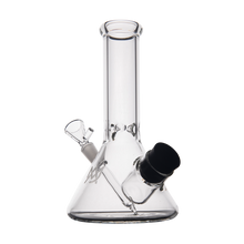The MJ Arsenal Cache Bong is a clear borosilicate glass beaker with a straight neck, angled downstem, and black accents on the bowl and joint, displayed against a plain white background.