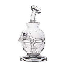 The MJ Arsenal Royale Vape Edition is a clear glass water pipe with abstract facial features and a slanted mouthpiece, designed as an artistic dab rig resting on a round flat base.