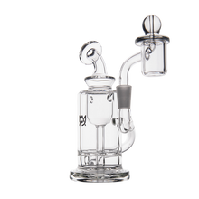 The MJ Arsenal Ursa Mini Dab Rig is a clear borosilicate glass rig with a cylindrical base, curved neck, and right-side attached glass dome and nail, designed for vaporizing concentrates.
