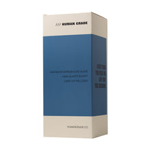 A rectangular box with a blue center and white top/bottom displays "HUMAN GRADE," “Handmade borosilicate glass, 10.25" Straight Recycler Glass Water Pipe, carb cap included,” and “humangrade.co” at the bottom.