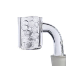 A close-up of a clear glass container with a curved handle displays MJ Arsenal Quartz Terp Pearls (6mm) against a white, minimalistic background—an ideal showcase for your dabbing accessories.