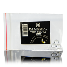 A clear plastic bag labeled MJ Arsenal Quartz Terp Pearls (6mm) holds three small quartz pearls, with a barcode and an illustration of dabbing accessories on the label.