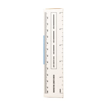 A close-up of the side of a rectangular white box labeled “Movement Health Check,” designed to measure optimal airflow for Human Grade Color Downstems (14MM) water pipe or downstem replacement, features vertical and horizontal ruler markings.