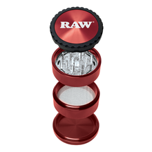 The RAW Life Grinder, a red 4-piece aircraft grade aluminum grinder, is shown separated vertically to display its grinding teeth, mesh screen, and storage compartment. The top lid features the RAW logo in white.