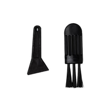 Two small black cleaning tools on a white background—ideal for your Human Grade Grinder 7F (2.5"): a flat scraper with a hole at the top and a compact brush featuring three stiff bristle rows and a ribbed handle.