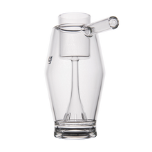 The MJ Arsenal Proxy Bubbler is a clear borosilicate glass accessory featuring a cylindrical spout and elevated chamber, highlighted by its modern geometric design on a white background.