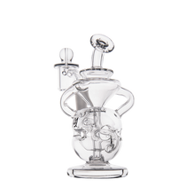 The MJ Arsenal Infinity Mini Dab Rig is a clear borosilicate glass recycler with swirling internal tubes, a round base, angled mouthpiece, and side attachment, shown against a plain white background.