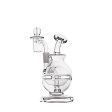The MJ Arsenal Royale Mini Dab Rig, made of clear borosilicate glass with a round base, angled mouthpiece, and quartz banger, is displayed against a plain white background.