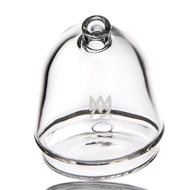 The MJ Arsenal The Bridge Puffco Peak Top is a clear glass dome with a round handle and etched MW logo. Designed for the Puffco Peak, it features smooth, curved edges and sits securely on flat surfaces.