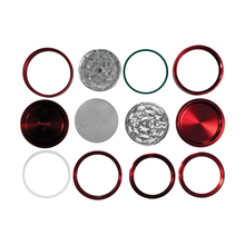 Twelve metal and plastic RAW Life Grinder parts in red, silver, green, and clear are arranged in a grid on a white background. The flat and ring-shaped pieces can be mixed and matched to customize your own grinder.