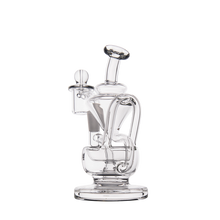 The MJ Arsenal Claude Mini Dab Rig is a clear glass water pipe with an intricate design of curved tubes and a round base, shown on a plain white background.