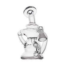 The MJ Arsenal Hydra Vape Edition is a clear mini dab rig with a curved neck, round base, and side percolator chamber featuring detailed glasswork, made for use with vaporizer pen adapters and shown on a white background.