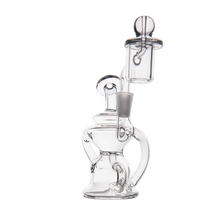 The MJ Arsenal Hydra Mini Dab Rig is a clear glass recycler with multiple chambers, curved tubing, a wide base, and a removable cap, shown against a plain white background.
