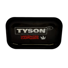 The Tyson 2.0 Rolling Trays are black, rectangular trays featuring "TYSON 2.0" in white, "UNDISPUTED CANNABIS" in red, and a small white leaf graphic—designed for legal use and available in various sizes.