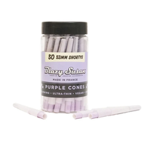 A clear plastic jar labeled Blazy Susan Purple Paper Cones holds 50 vibrant purple 53mm shortys pre-rolled cones, with two cones displayed in front and the label reading "50 53mm Shortys and Purple Cones.