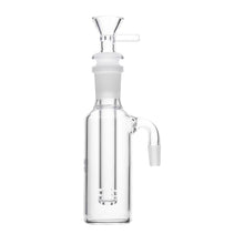 The Human Grade Tube Ash Catcher is a clear glass ash catcher with a vertical chamber, 14mm joint, removable bowl on top, and side joint for easy water pipe attachment.