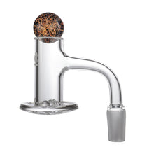 A clear glass dab rig attachment with a curved neck and round base, featuring a marble cap with mottled brown and black pattern, perfectly paired with the MJ Arsenal Full Weld Quartz Terp Blender for smooth hits.