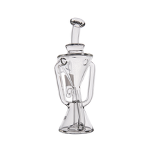 The MJ Arsenal Time Turner Mini Dab Rig is a clear borosilicate glass rig with an artistic hourglass-shaped base and curved tubes, showcased against a plain white background.