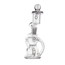 The MJ Arsenal Hydra Mini Dab Rig, featuring a transparent glass build with a cylindrical chamber, curved mouthpiece, and round base, is displayed against a white background.