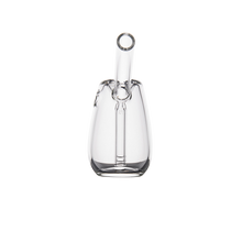 The MJ Arsenal Bulb Bubbler, crafted from clear borosilicate glass with a cylindrical spout and rounded body, is displayed against a plain white background. Its design is modern, minimalist, and easily portable.