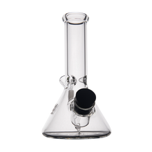 The MJ Arsenal Cache Bong is a clear borosilicate glass beaker with a wide base, straight neck, and a black removable bowl on the side, shown against a plain white background.