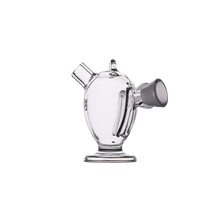 The MJ Arsenal Dubbler Original Double Bubbler is a clear borosilicate glass piece with a rounded body, angled spout, vertical handle, and wide base for water filtration, shown against a plain white background.