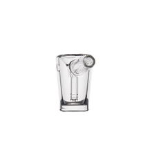 The MJ Arsenal Basin Bubbler is a clear borosilicate glass shot glass featuring a hollow cylindrical tube in the center, resembling a mini bubbler, shown against a plain white background.