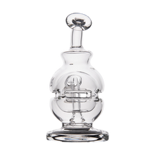 The MJ Arsenal Royale Vape Edition is a clear glass sculpture with a rounded body, detailed internal glasswork, and a flat circular base—resembling an artistic decanter or decorative dab rig.