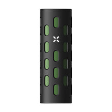 The PAX Flow Vaporizer with Grip Sleeve Bundle is a black cylindrical dry herb vape, featuring oval cutouts showing a green inner sleeve and a white, four-petaled flower symbol—designed with the advanced PAX Flow hybrid heating system.