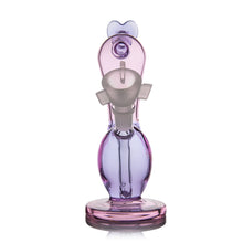 The MJ Arsenal Burning Heart (Valentine's 2024) is a limited edition borosilicate glass water pipe in purple and pink, featuring a round base, oval body, and circular mouthpiece—perfect for special occasions.