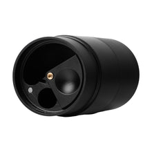 A close-up of the MJ Arsenal Capsule Grinder Dugout shows its black matte finish, cylindrical shape, small metal lid accent, and partially open rotating top revealing two inner compartments.