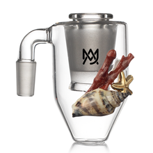The MJ Arsenal Reclaim / Dry Ash Catcher is a transparent glass cup with a metal and quartz insert, adorned with a lifelike seashell, red coral, and gold starfish. Its front showcases a sleek black logo inspired by MJ Arsenal Mini Rigs.