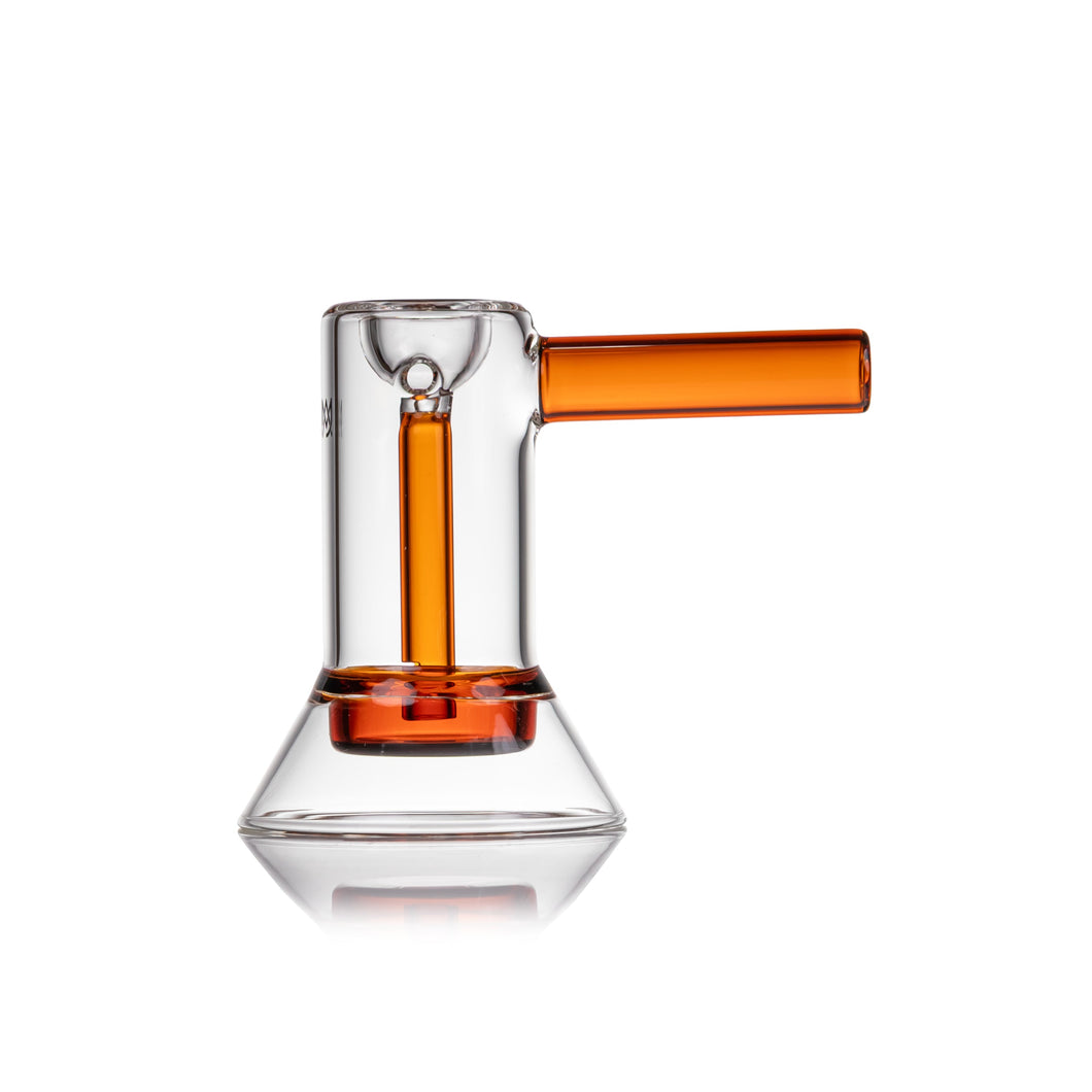 The MJ Arsenal Cove Glass Bubbler, made of clear borosilicate glass with a conical base, cylindrical body, and orange handle and interior, is shown against a white background.
