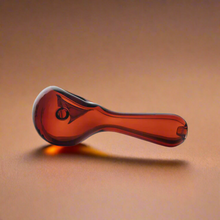 Red glass pipe on a brown background
