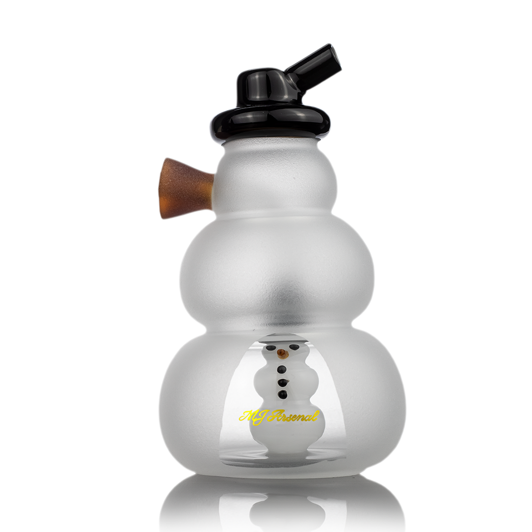 The MJ Arsenal Snowperson Blunt Bubbler is a compact borosilicate glass water pipe with a frosted finish, black mouthpiece, brown side piece, inner snowman figure, and 