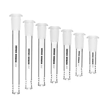 Seven clear Human Grade Downstems of different heights, each fitted with a white stopper and labeled "HUMAN GRADE," are lined up from tallest to shortest, resembling 10mm or 14mm water pipe replacement downstems.