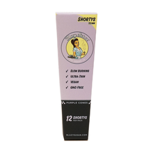 A purple Blazy Susan Purple Paper Cones box with an illustrated woman highlights slow burning, ultra-thin, vegan, GMO free features. Inside are 12 Shortys—purple pre-rolled cones, each 53mm for a smooth smoke.