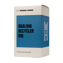 A beige and blue box labeled Human Grade contains the Dualing Recycler Glass Rig Water Pipe, featuring a 14mm Quartz Bucket and borosilicate glass rig, with an abstract line illustration displayed on the side.