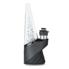 A sleek, modern Puffco New Peak Pro with a clear glass cone-shaped top, textured black base, and attached 3D XL Chamber for advanced dabbing.
