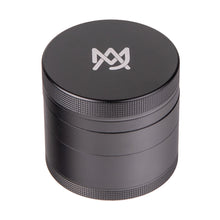 The MJ Arsenal 4 Piece Grinder is a black cylindrical aluminum grinder with textured edges and a white geometric logo on the lid, displayed on a white background.