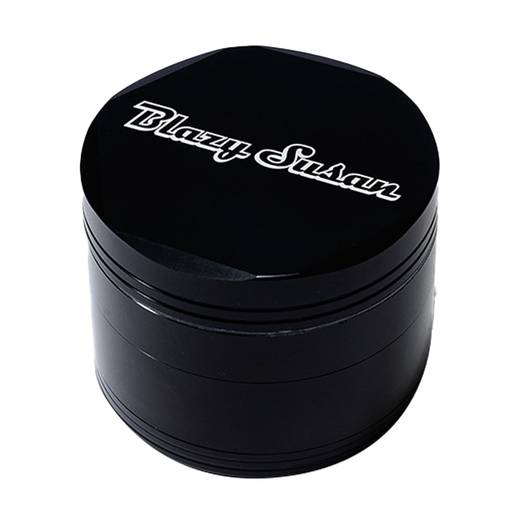 The Blazy Susan Grinder V2 is a black, round aluminum grinder featuring a spacious grind chamber and 