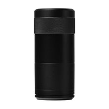 The MJ Arsenal Capsule Grinder Dugout is a black, cylindrical device with a textured grip near the top, resembling a portable dugout, shown against a plain white background.