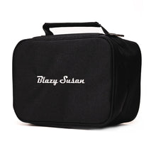 The Blazy Susan Stash Bag is a black rectangular, smell-proof bag with a handle and zipper. “Blazy Susan” is embroidered in white on the front. Rolling tray compatible for discreet, organized storage.