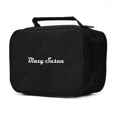 The Blazy Susan Stash Bag is a black rectangular, smell-proof bag with a handle and zipper. “Blazy Susan” is embroidered in white on the front. Rolling tray compatible for discreet, organized storage.
