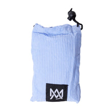 The MJ Arsenal Padded Drawstring Pouch is light blue with ribbed fabric, a black toggle, and a front black patch with a white geometric logo—ideal for storing glass accessories. Shown against a white background.