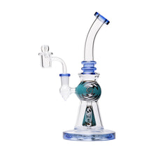 The Human Grade 10" Mini Gumball Rig Glass Water Pipe features blue accents, an intricate teal and black central chamber design, a bent neck, wide base, and a side dome-and-nail attachment.