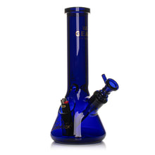 The Gear Premium 12" Sidekick (Beaker) Water Pipe is a dark blue borosilicate bong with a wide base, side mouthpiece, and upright design. "GEAR" is printed on the neck, and a black and red lighter rests inside the base.