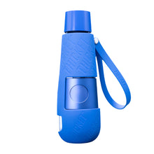 The Thicket V2 Water Pipe is a blue, smell-proof portable smoking device featuring a silicone sleeve embossed with THICKET, a round central button, and a matching wrist strap attached to the side.